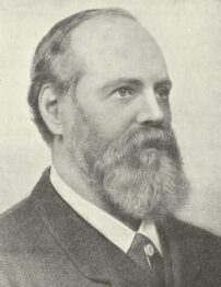 A black and white portrait of a light-skinned man with a beard.