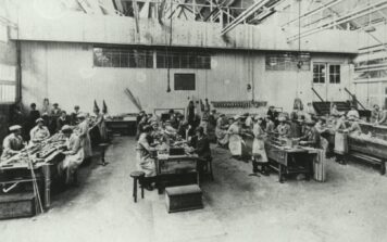 A black and white photograph of women working in a factory.
