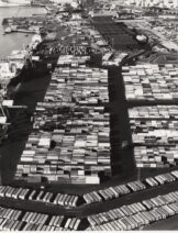 A black and white aerial photograph of containers at a port.
