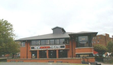 A photograph of a large building, constructed with red bricks.