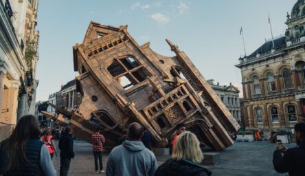 A photograph of an art installation - a large building constructed of tape and cardboard.